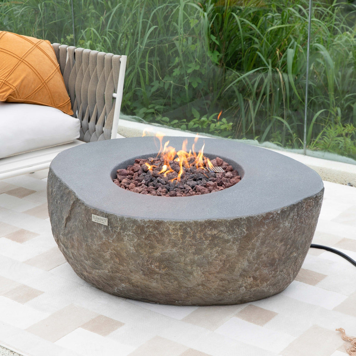 Boulder propane fire table in an outdoor lounge