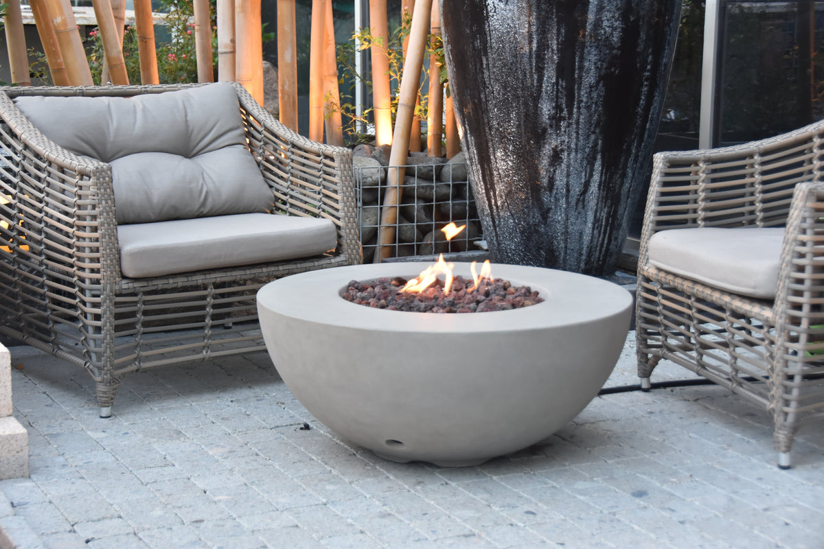 Modeno Roca round fire table in a patio lounge setting