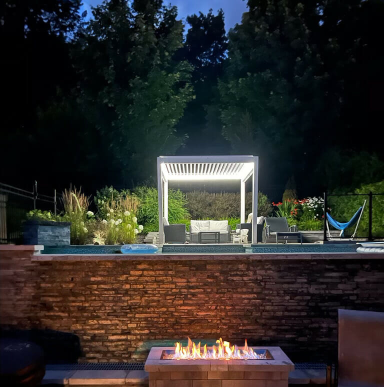 White Procam Villa pergola photographed in an evening garden